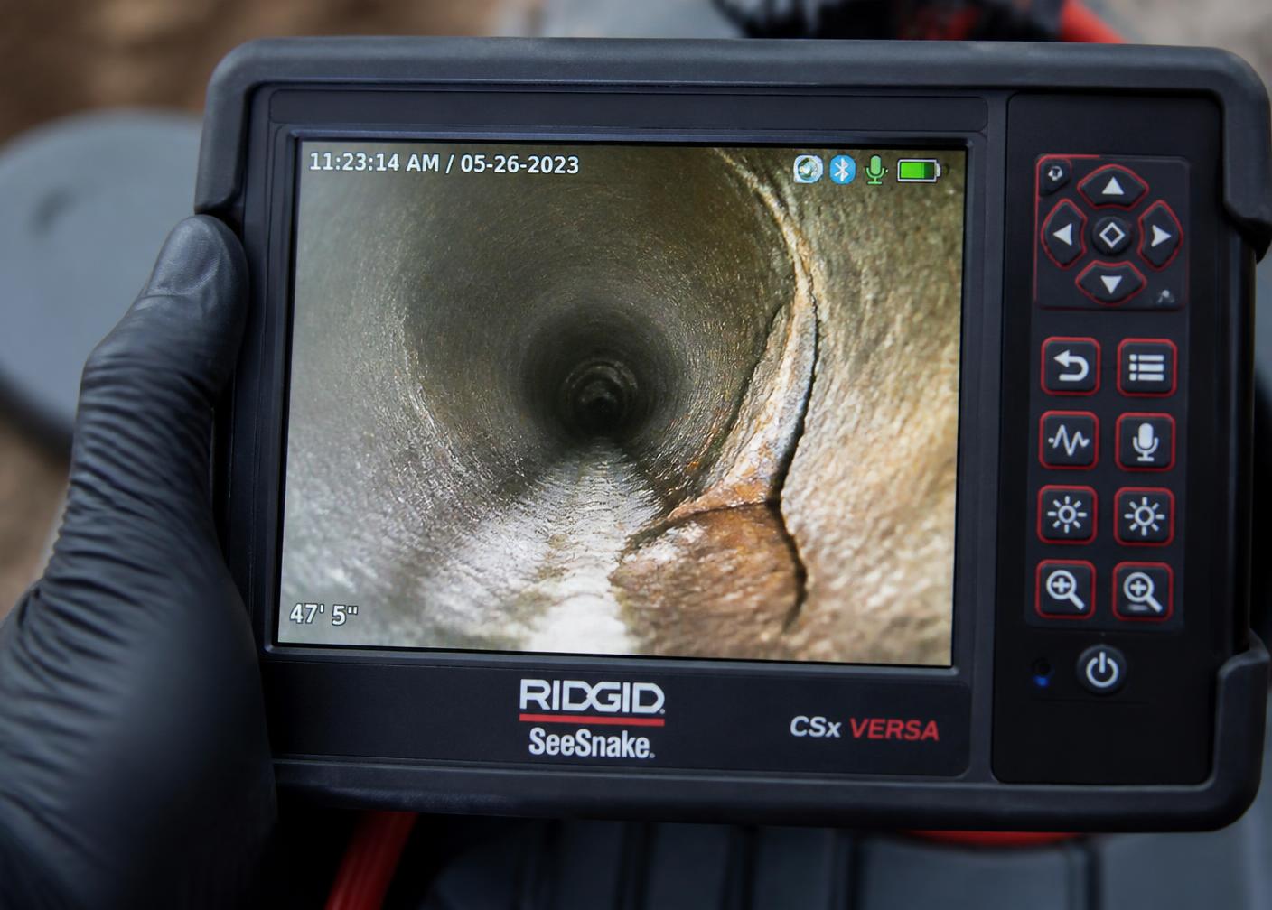 Plumbing camera monitor showing the inside of a sewer pipe during a sewer camera inspection